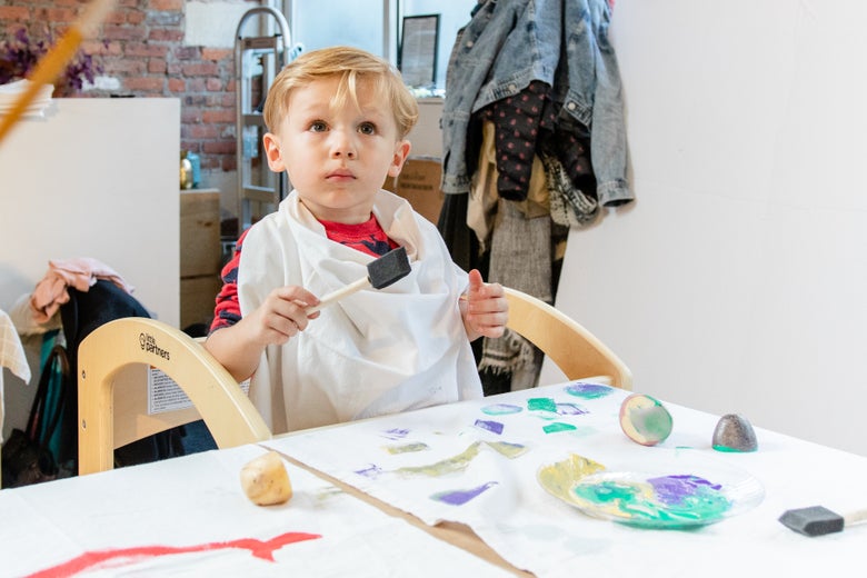 Child with bib for art project